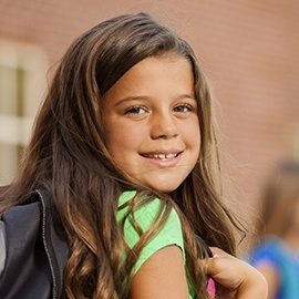 Smiling little girl with backpack