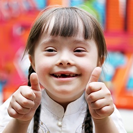 Young girl giving thumbs up