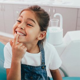 a child patient smiling during her dental checkup