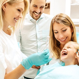 Young girl at dentist with parents 