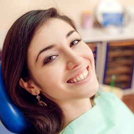 A young female sitting back in the dentist’s chair after having a fluoride treatment