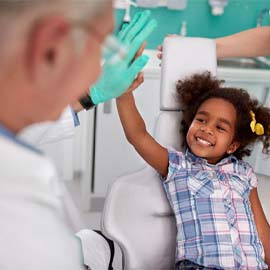 little girl giving her dentist in Midland a high five
