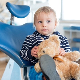 little boy at dental appointment with teddy bear