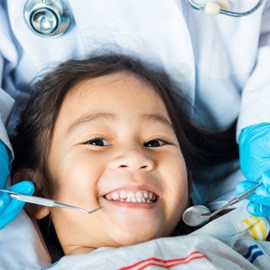 child smiling while visiting dentist   