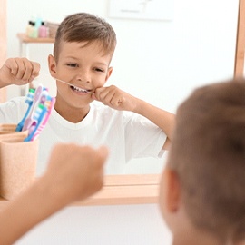 Little boy flossing to prevent children’s toothache Midland