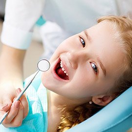 Little girl receiving dental exam