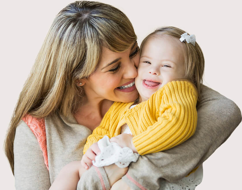 Mother kissing laughing toddler