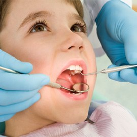 a child having their teeth cleaned