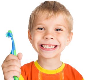 a boy holding a toothbrush