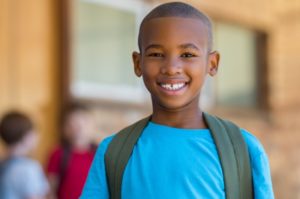 middle schooler smiling with backpack on