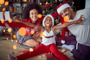 child with their parents celebrating the holidays