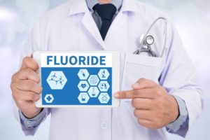 pediatric dentist in Midland pointing to fluoride on tablet 