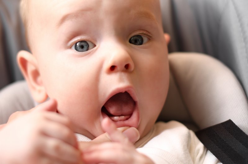 Baby with baby teeth erupting