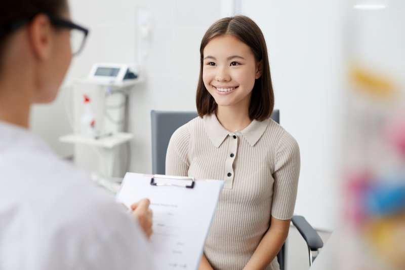 Teen smiling at dentist appointment