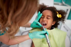 Young girl getting a fluoride treatment for preventing cavities in kids