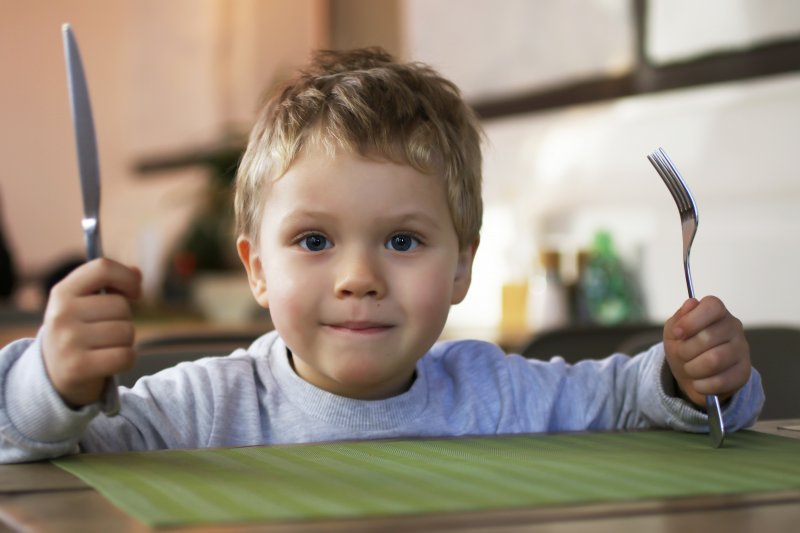 Child with fork and knife