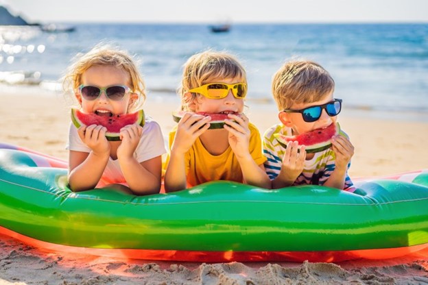 Children smiling during the summertime.