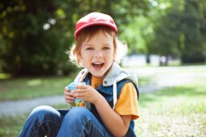 child drinking juice box