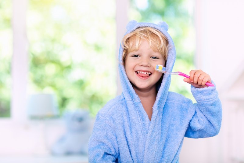 portrait of a kid brushing their teeth