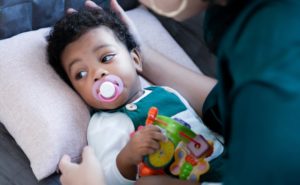 a baby sucking on a pacifier