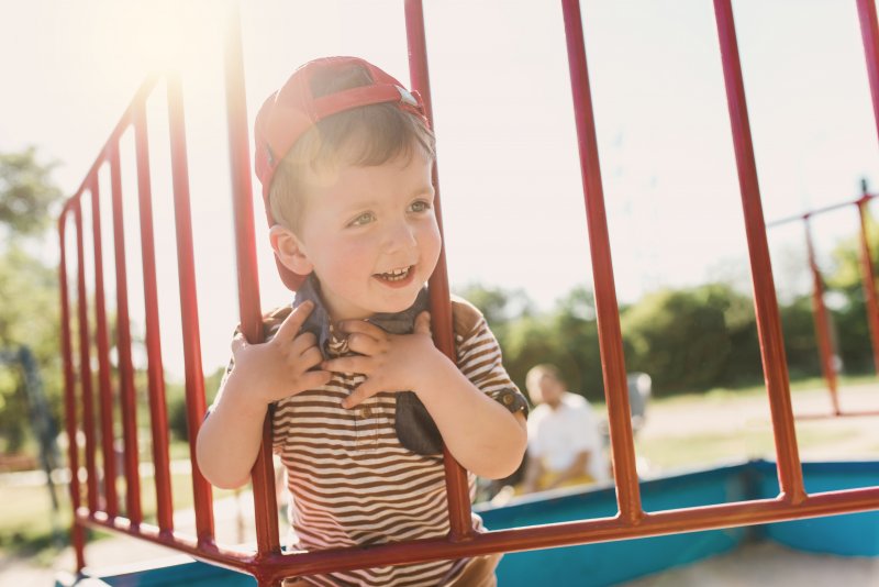 little boy smiling on playground