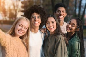 Group of teens smiling. 