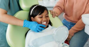 Little girl smiling while in the dentist’s chair